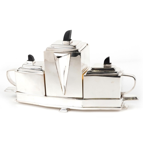 1277 - An Art Deco style plated teapot together with a sugar pot and milk jug on a stand, 40cm wide.