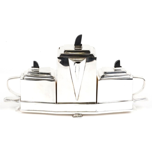 1277 - An Art Deco style plated teapot together with a sugar pot and milk jug on a stand, 40cm wide.