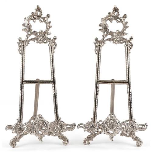 1276 - A pair of Rococo style brass easel stands, each 41cm high.