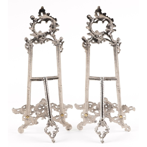 1276 - A pair of Rococo style brass easel stands, each 41cm high.