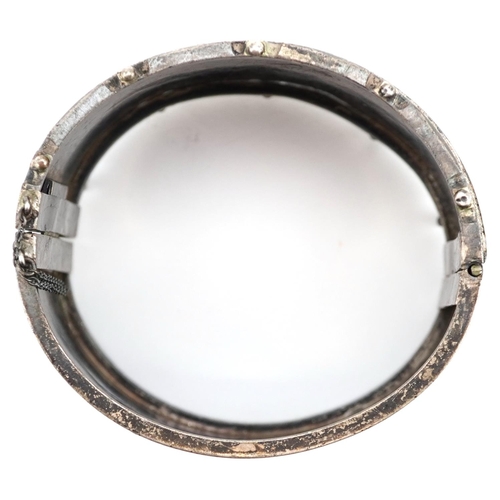 618 - A large Victorian unmarked silver hinged bangle, 6cm wide x 3.5cm high, 55.0g.