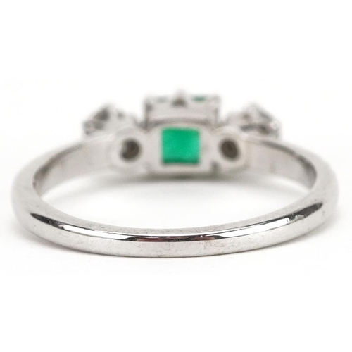 29 - An 18ct white gold emerald and diamond ring, each diamond approximately 3.10mm in diameter, the emer... 