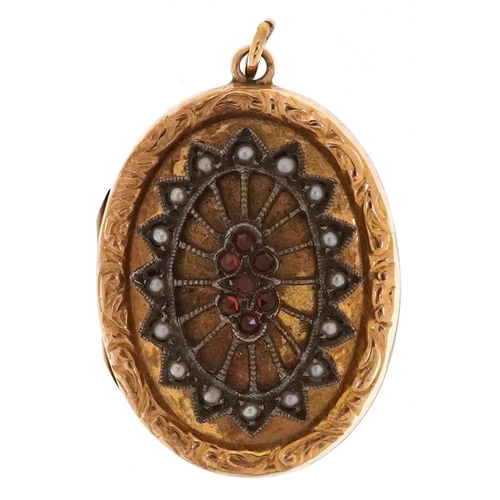 291 - A 9ct gold back and front and silver locket set with garnets and seed pearls, 2.5cm high, 4.7g.