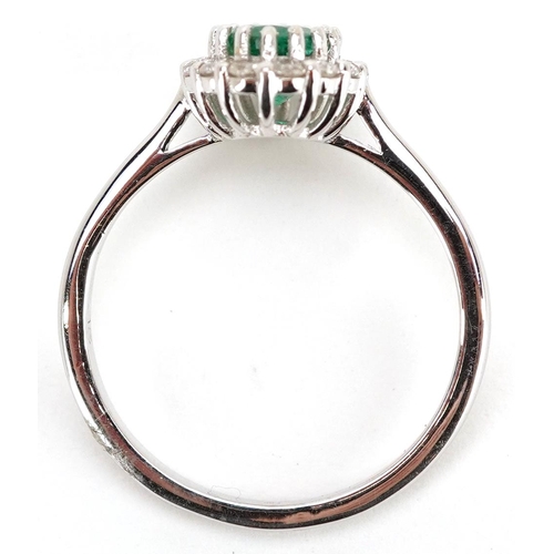 188 - An 18ct white gold emerald and diamond cluster ring, total diamond weight approximately 0.30 carat, ... 