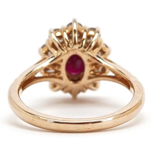 180 - A 9ct gold ruby and diamond cluster ring, total diamond weight approximately 0.83 carat, the ruby ap... 