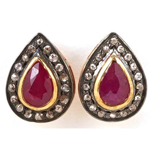 61 - A pair of silver gilt ruby and diamond teardrop stud earrings, total diamond weight approximately 0.... 