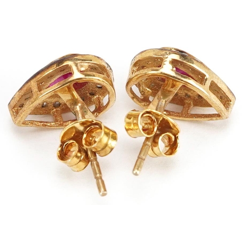 61 - A pair of silver gilt ruby and diamond teardrop stud earrings, total diamond weight approximately 0.... 