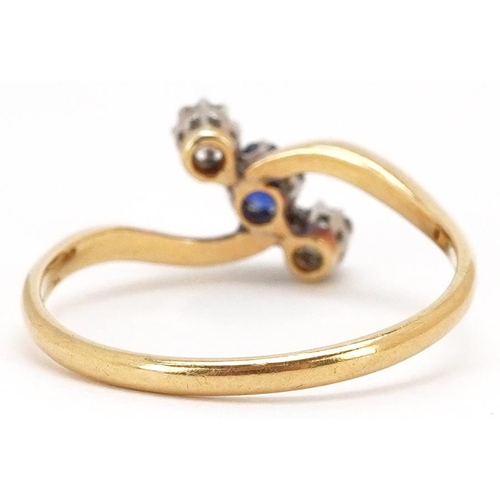 41 - An antique unmarked gold diamond and sapphire three stone crossover ring, total diamond weight appro... 