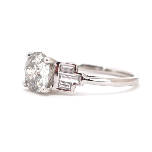 296 - An 18ct white gold old cut solitaire diamond ring with baguette cut diamond set shoulders, the solit... 