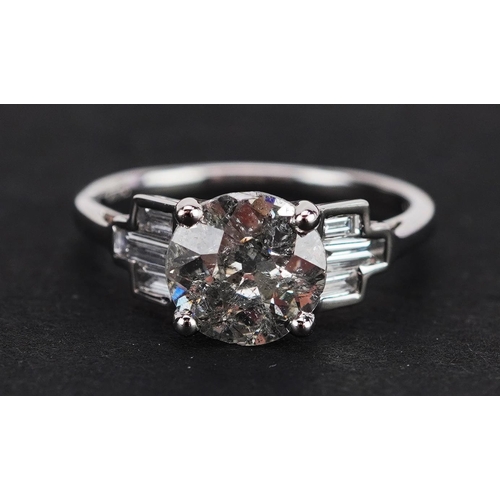 296 - An 18ct white gold old cut solitaire diamond ring with baguette cut diamond set shoulders, the solit... 