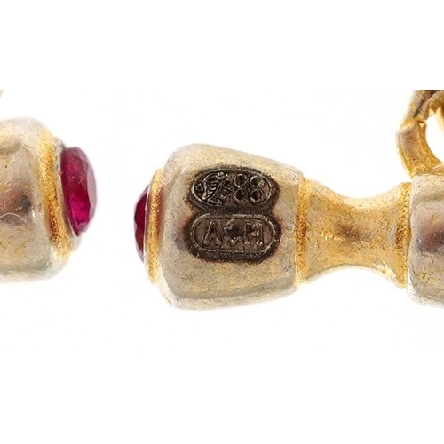 139 - A pair of silver gilt and enamel dog's head design cufflinks set with pink stones, 2.5cm wide, total... 