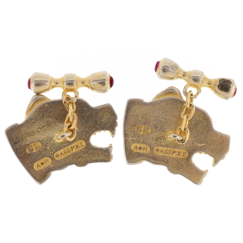 139 - A pair of silver gilt and enamel dog's head design cufflinks set with pink stones, 2.5cm wide, total... 