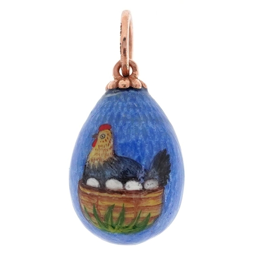 428 - A 14ct gold guilloche enamel egg pendant hand painted with a chicken and eggs in a basket, impressed... 