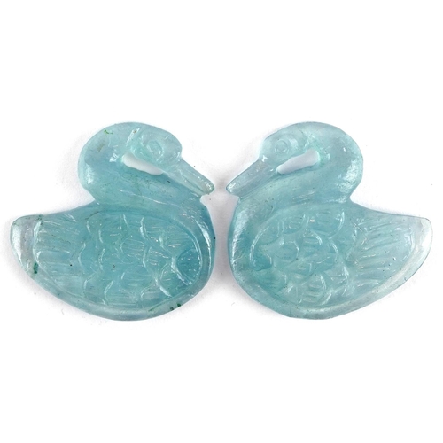 619 - A pair of pale blue glass swan design panels, 2.5cm high.