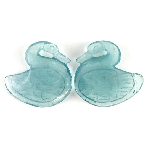 619 - A pair of pale blue glass swan design panels, 2.5cm high.