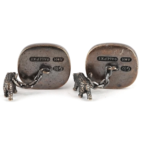 479 - A pair of silver gilt elephant and bear design cufflinks set with blue stones, impressed Russian mar... 