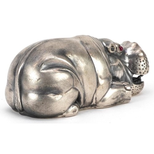 672 - A silver recumbent hippopotamus with cabochon ruby eyes, impressed Russian marks, 7.5cm in length, 8... 