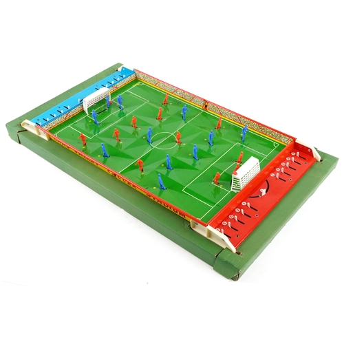 541 - A Chad Valley soccer game, the metal pitch with plastic moveable figures, 59cm in length, boxed.