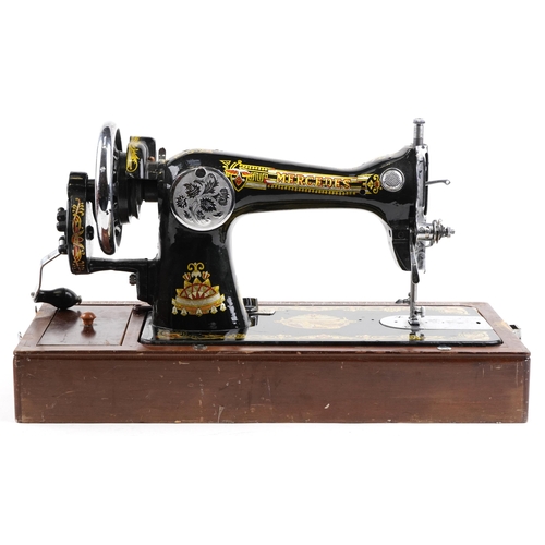 1291 - An early 20th century Mercedes Super Deluxe sewing machine with gilded and engraved decoration, case... 