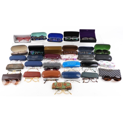 1285 - A collection of various vintage spectacles with cases.