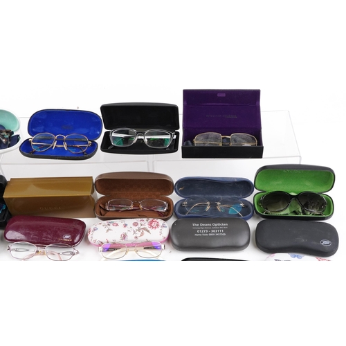 1285 - A collection of various vintage spectacles with cases.