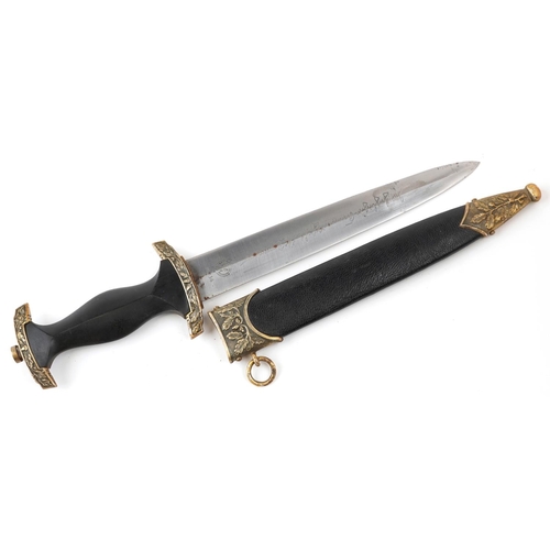 747 - A German military interest dagger with scabbard, 37cm in length.