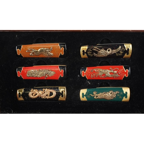 1249 - A group of six Franklin Mint Collector knives, various designs, within a display case, 34cm wide.