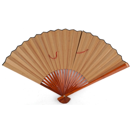 1379 - A large Chinese hand painted folding fan, mid 20th century, decorated with flowers, 61cm in length.