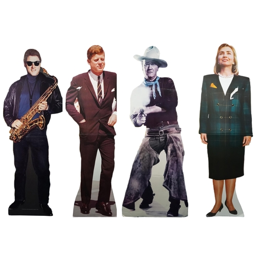 Four late 20th century life sized cardboard cut-outs of Bill Clinton, Hilary Clinton, John F Kennedy and John Wayne, 186cm high.