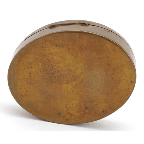 210 - An early 20th century oval brass and enamelled box with floral decoration, W-7cm.