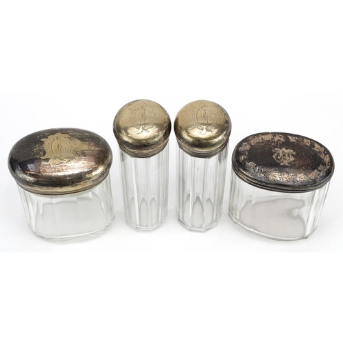 234 - Four silver topped glass dressing table jars, worn marks, H-12cm.