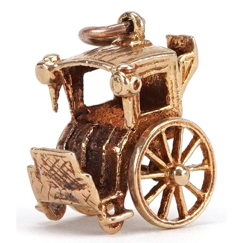 77 - A 9ct gold charm in the form of a horse and carriage, 1.7cm high, 4.9g.