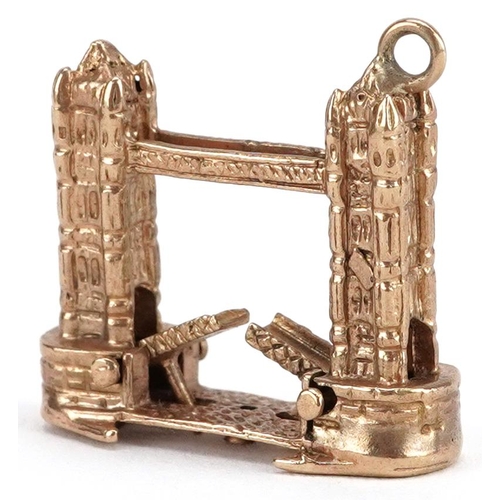 164 - An unmarked 9ct gold charm in the form of Tower Bridge with opening bridge, 2cm high, 6.6g.