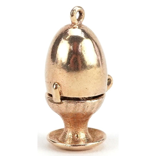 155 - A 9ct gold charm in the form of an egg opening to reveal a chick, 2.3cm high, 5.5g.