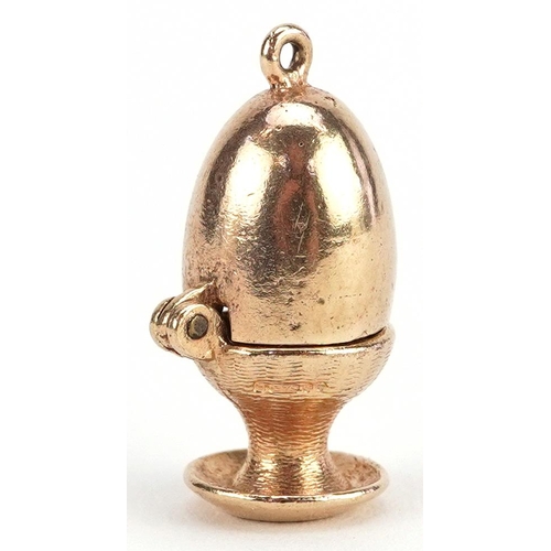 155 - A 9ct gold charm in the form of an egg opening to reveal a chick, 2.3cm high, 5.5g.