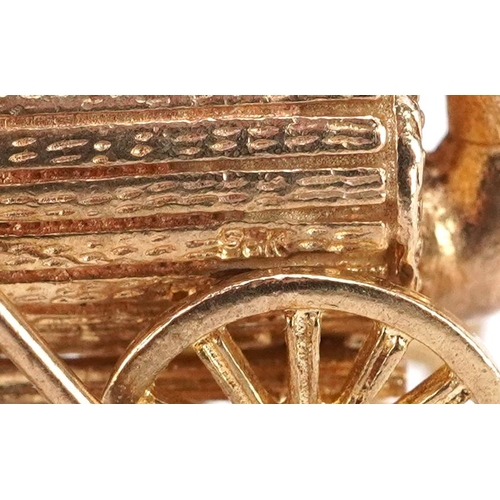 38 - A 9ct gold charm in the form of Stephenson's Rocket steam engine, 2.1cm in length, 7.0g.