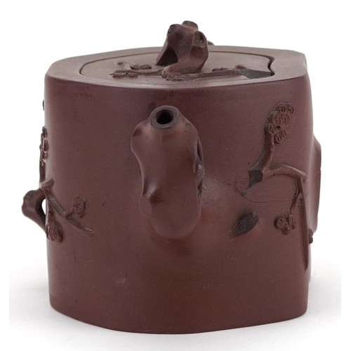 183 - A Chinese Yixing stoneware teapot, 20th century, with naturalistic decoration, 10cm high.