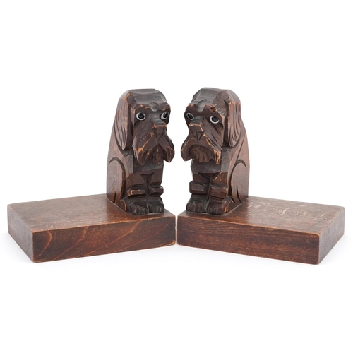 1168 - A pair of naive continental carved walnut bookends in the form of seated terriers, 12cm H x 11cm W x... 