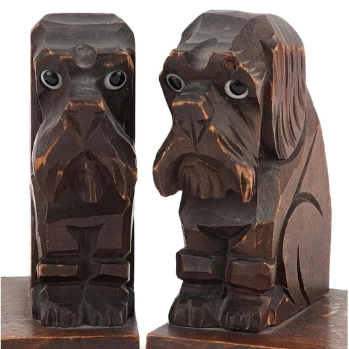 1168 - A pair of naive continental carved walnut bookends in the form of seated terriers, 12cm H x 11cm W x... 