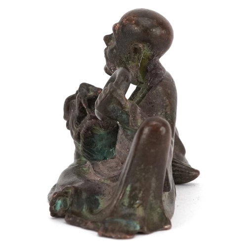 1157 - A Japanese patinated bronze okimono of a gentleman and Foo dog, impressed marks to the base, 6.5cm i... 