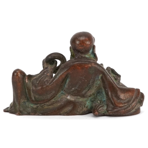 1157 - A Japanese patinated bronze okimono of a gentleman and Foo dog, impressed marks to the base, 6.5cm i... 