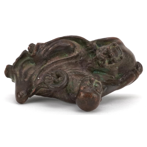 1157 - A Japanese patinated bronze okimono of a gentleman and Foo dog, impressed marks to the base, 6.5cm i... 