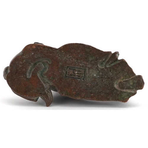 1157 - A Japanese patinated bronze okimono of a gentleman and Foo dog, impressed marks to the base, 6.5cm i... 