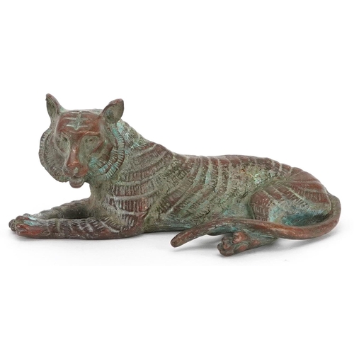 1336 - A Japanese patinated bronze okimono of a tiger, impressed marks, 7cm in length.