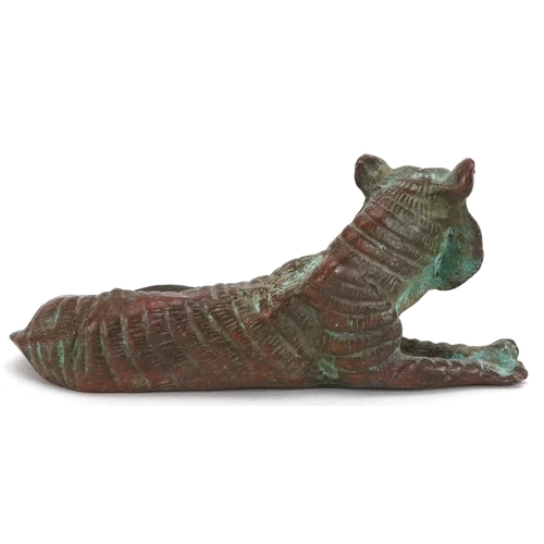 1336 - A Japanese patinated bronze okimono of a tiger, impressed marks, 7cm in length.