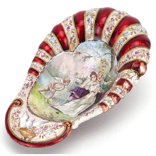 1351 - A French enamelled shell shaped bowl decorated with a female and Putti, 12cm in length.