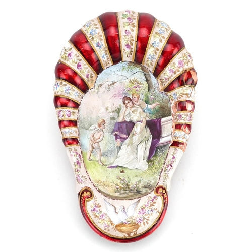 1351 - A French enamelled shell shaped bowl decorated with a female and Putti, 12cm in length.