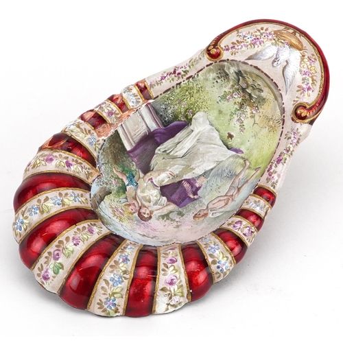 1351 - A French enamelled shell shaped bowl decorated with a female and Putti, 12cm in length.