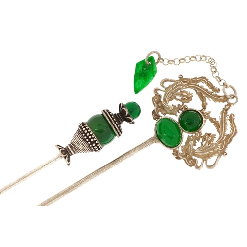 1254 - Two Middle Eastern white metal hairpins set with green stones, the largest 17cm in length.