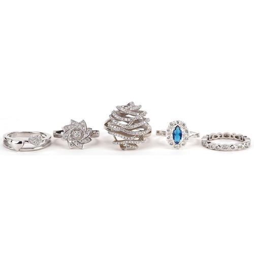 2501 - Five silver rings set with blue and clear stones, various sizes, total 19.4g.